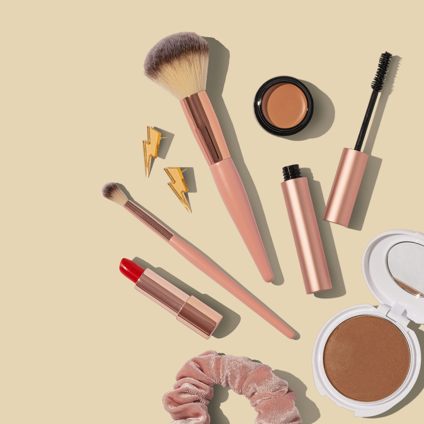 Everyday makeup brushes arranged on a lived-in bedroom vanity