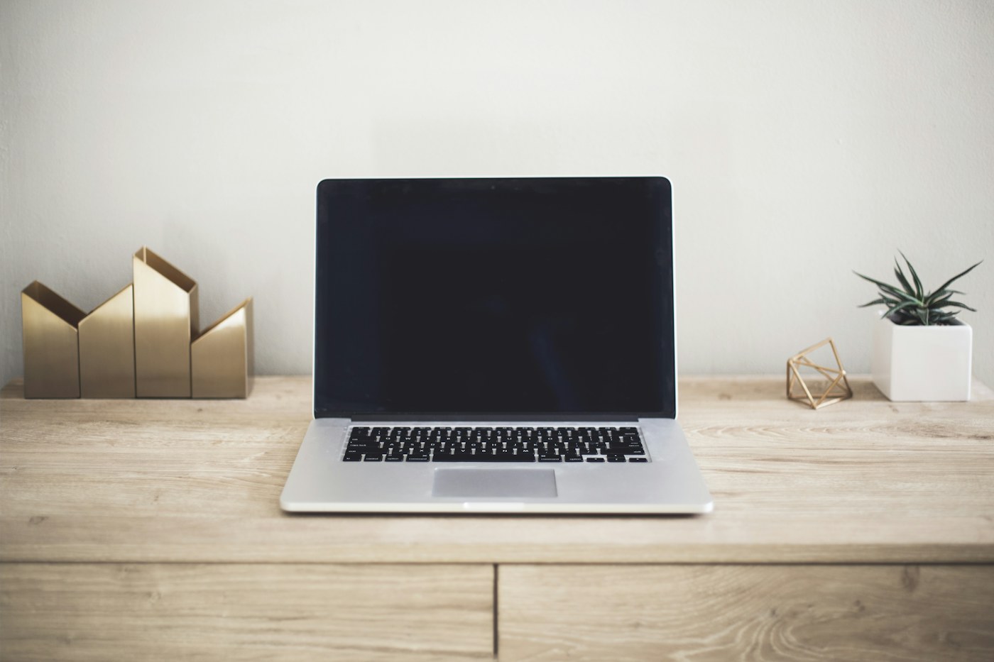 A laptop connected through a USB-C hub to a monitor and desk accessories